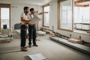 two general contractors reviewing plans during remodel